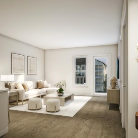 a living room with a white couch and a white table
