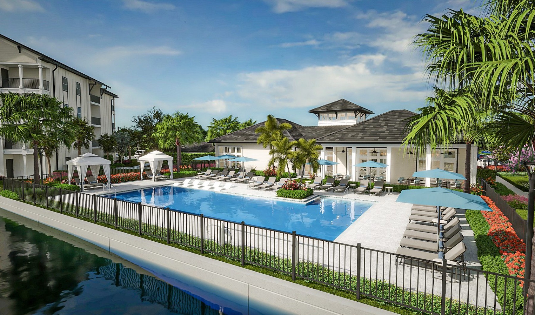 a courtyard with a pool, chairs and umbrellas