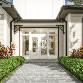 a building with white doors and bushes